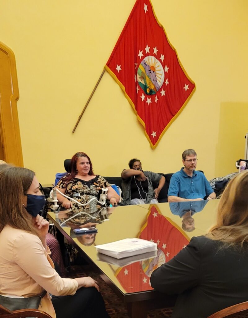 Advocates sitting at a conference table in a committee meeting at the Ohio State Capital.